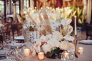 Rustic wedding decorations with flowers and candles. banquet decor.