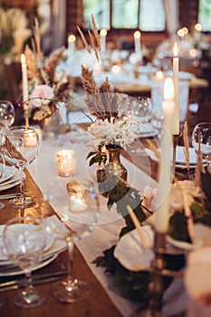 Rustic wedding decorations with flowers and candles. banquet decor.