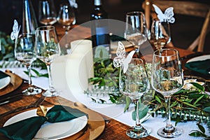 Rustic wedding table setting in fancy american restaurant. Vintage decoration of reception table. Elegant arrangement of the