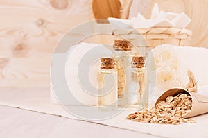 Rustic white homemade cosmetics set of natural products for body care and bath accessories with spikelets closeup in light beige.