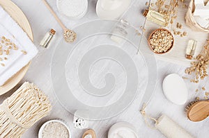 Rustic white homemade cosmetics set of natural products for body care and bath accessories with spikelets on white wood board.