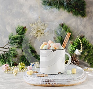 Rustic white mug marshmallows for Christmas and New Year on a wooden white table, selective focus