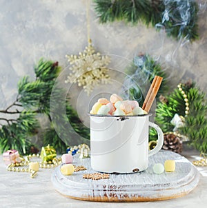 Rustic white mug marshmallows for Christmas and New Year on a wooden white table, selective focus