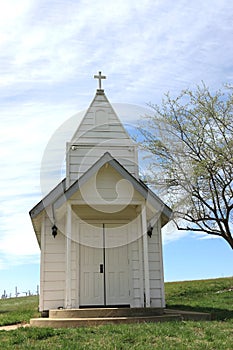 Rustic white wooden chapel in the countryside.