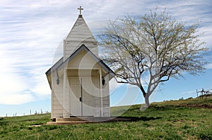 Rustic white wooden chapel in the countryside.