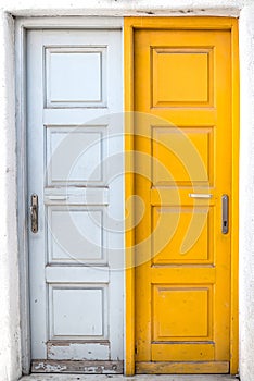 Rustic white and yellow doors of Greek island