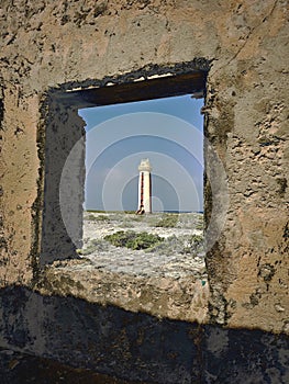 Rustic Window View of a caribbean Seaside Lighthouse