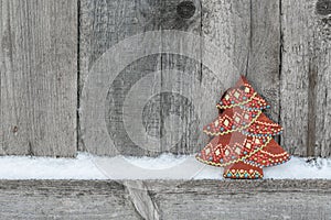Rustic winter background with wooden Christmas tree on wooden texture. Christmas and New Year greeting card background