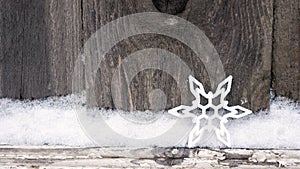 Rustic winter Christmas background with snowflake on wooden texture. Christmas and New Year greeting card background