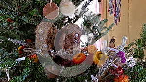 Rustic winter holidays decorations on a Christmas tree
