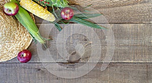 Rustic wood autumn background with straw hat, fresh apples and c