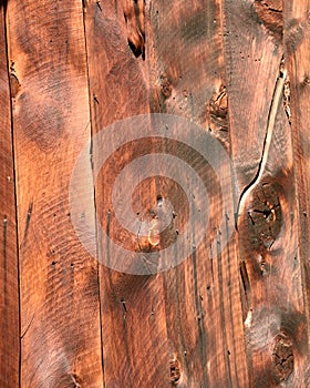 Rustic wood cabin siding of settlers cabin in mining camp in Idaho mountains. Rustic wood grain design