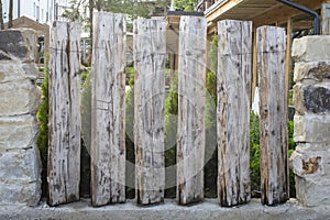 Rustic wood fence with big stones and cement