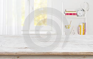 Rustic wood table for product display over blurred schooler room