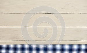 Rustic wooden background with blue checkered fabric