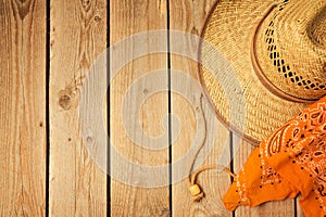Rustic wooden background with cowboy hat and bandanna