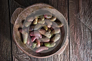 Rustic wooden bowl filled with melloco tuber