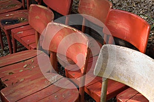 Rustic wooden chairs stored outdoors