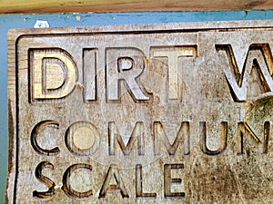 Rustic Wooden Community Sign with Carved Lettering Close-Up