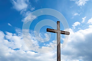 rustic wooden cross against a cloudy sky