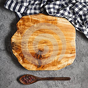 Rustic wooden cutting board on grey cement surface top view