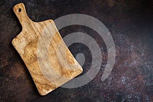 Cutting board on rusty metal background