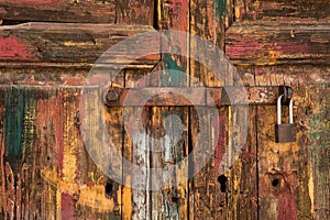 Rustic Wooden Door with Padlock and Worn Paint