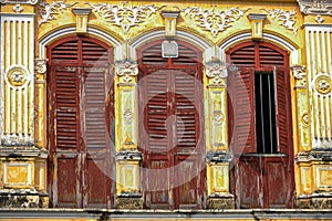 Rustic wooden doors of classic sino portuguese architecture in old town Phuket Thailand