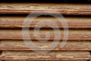 A rustic wooden fence or wall of pine shapes