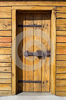 Rustic wooden fortress door with old iron latch