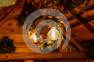 a rustic wooden hut with a glowing light bulb