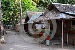 Rustic wooden huts street asian village. Native lifestyle travel photo. Traditional lifestyle of fishermen on sea shore