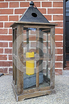 Rustic wooden lantern decoration at the entrance of a house