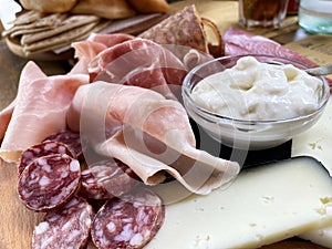 Rustic wooden serving tray with typical products of Italian Emilia-Romagna region