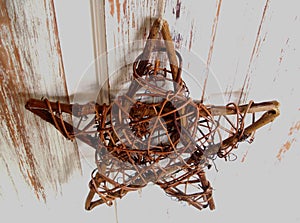 Rustic Wooden Star, from Above, Hanging on a White Door