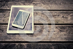 Rustic wooden table with digital tablet and smartphone. View from above