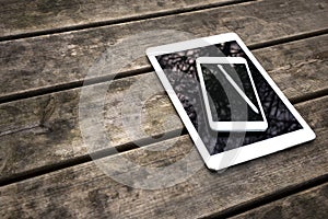 Rustic wooden table with digital tablet and smartphone. View from above