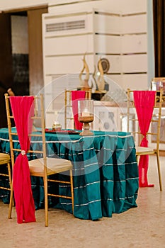 Rustic wooden table is set with vibrant red and blue linens
