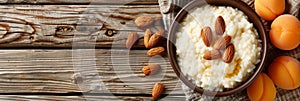 Rustic wooden table setting with arroz com amendoas e creme de damasco dish on white plate