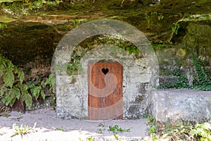 Rustic wooden toilet in the mountain with a heart-shaped hole in the door boards