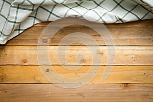 Rustic wooden with white checkered table cloth.