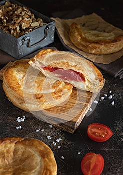 Rustico puff pastry from Lecce filled with stuffed with tomato, mozzarella and bechamel sauce photo