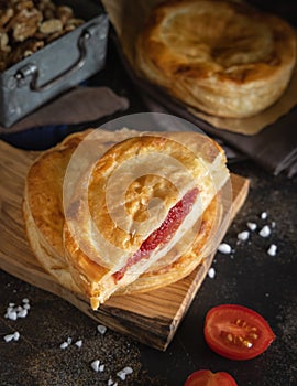 Rustico puff pastry from Lecce filled with stuffed with tomato, mozzarella and bechamel sauce photo
