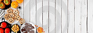 RusticRustic Halloween treat corner border over a white wood banner background