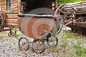 Rusting antique baby carriage