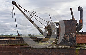 The rusting crane and boom of the Tramp Steamer Portlairge wrecked on the beach at St Kieran`s Quay.