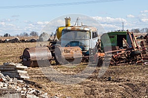 Rusting farm machinery in a field