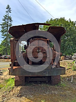 Rusting forestry equipment in green field