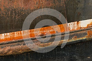 Rusting hull and peeling paint on an old deep sea fishing trawler