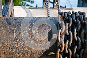 Rusting metal chains on iron spool